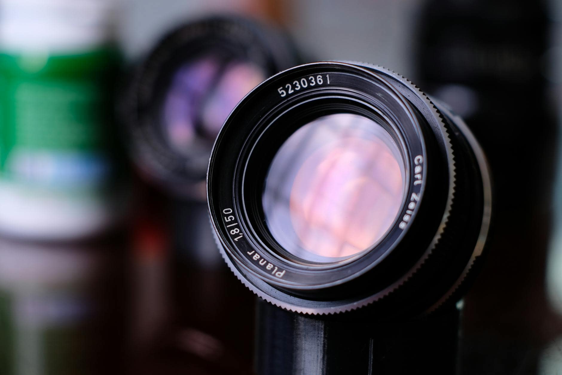cinema lenses - Detailed shot of a Carl Zeiss Planar T* 50mm f/1.4 lens, showcasing its precision.