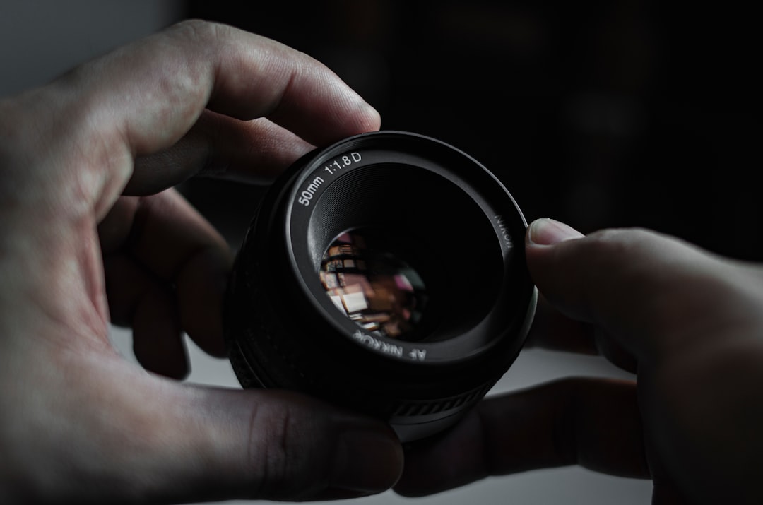 7 Stunning 7artisans Vintage Lens Photos REVEALED! 9 person holding black camera lens
