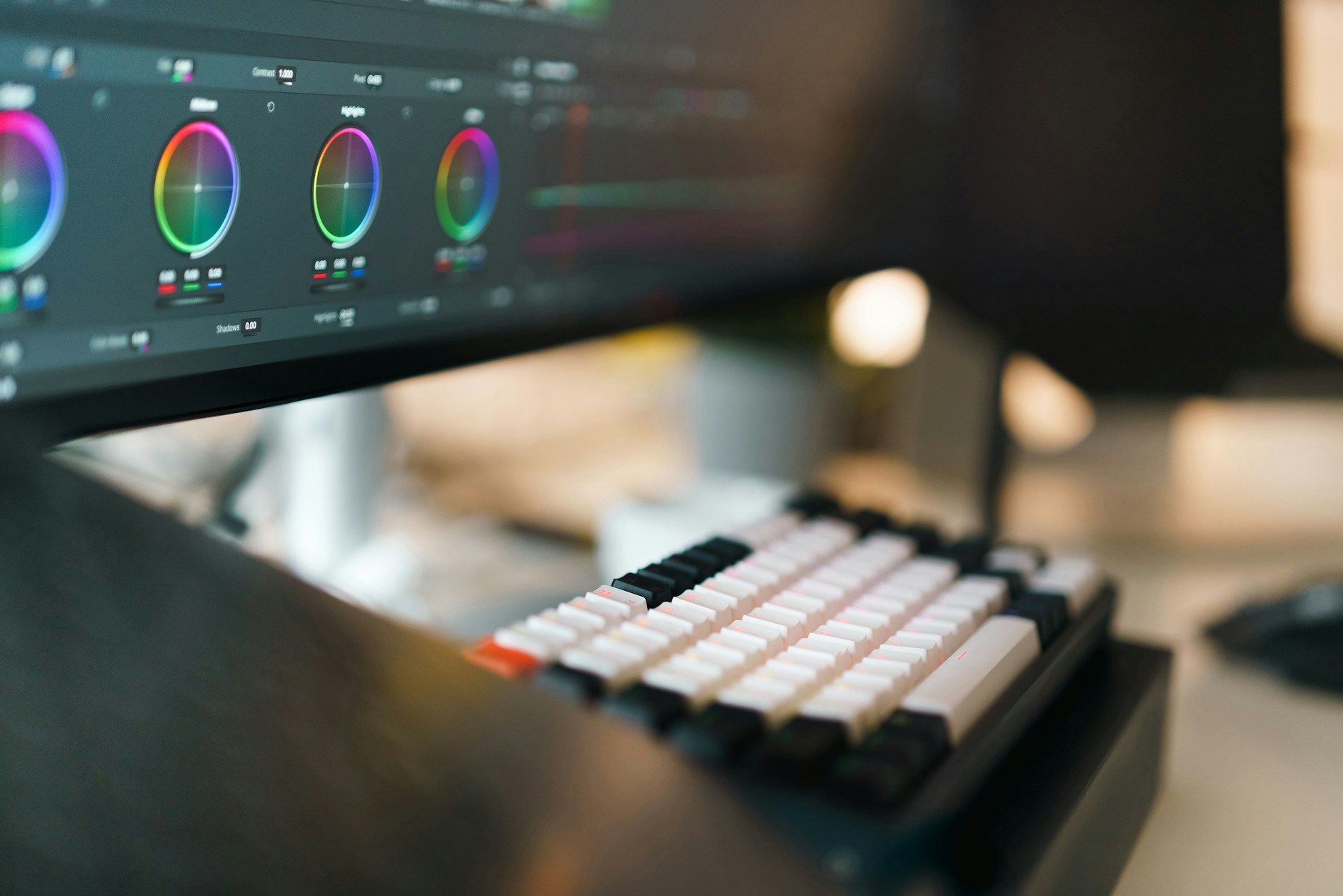 DaVinci Resolve color grading wheels displayed on a monitor in a home edit suite.