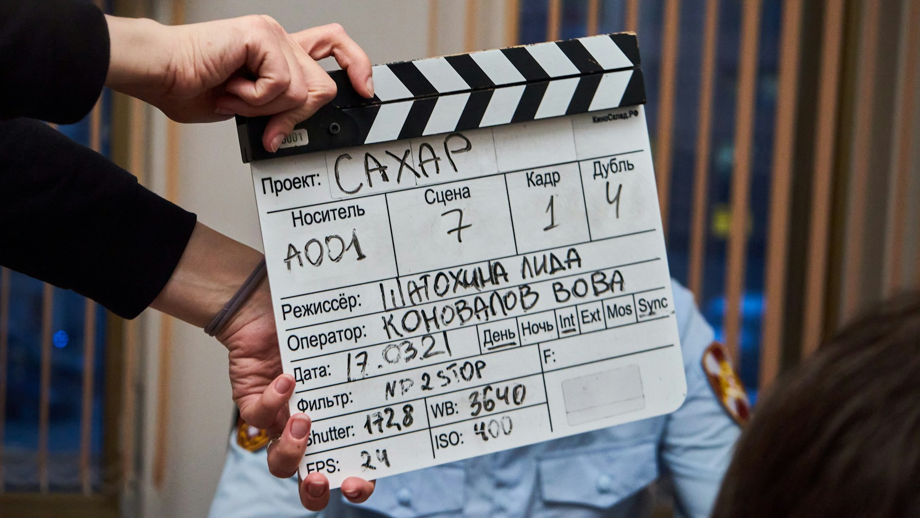 A clapperboard held on a short film set, marking a shot in production.