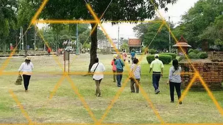 Visitors walking through a park framed by yellow triangles in 9 Temples to Heaven, Thailands Oscar entry
