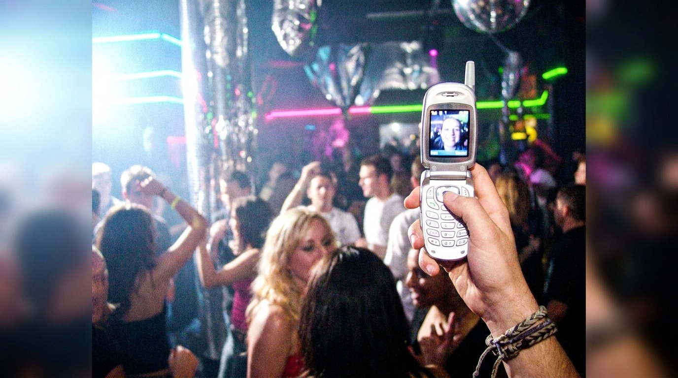 A persons hand holds up an early 2000s flip phone, y2k prompts