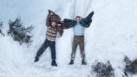 Ryan Reynolds and Kenneth Branagh lying in the snow in Mayday